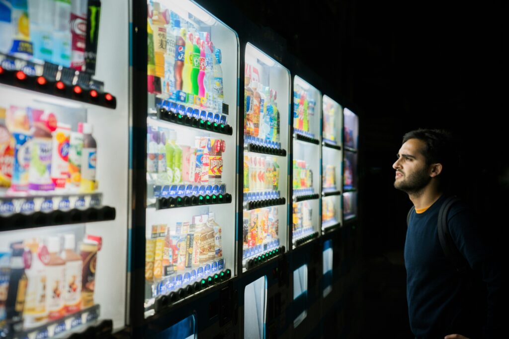 a man standing in front of a shelf full of products. he is having decision paralysis and needs WhichIsBetterAI decision making mobile app